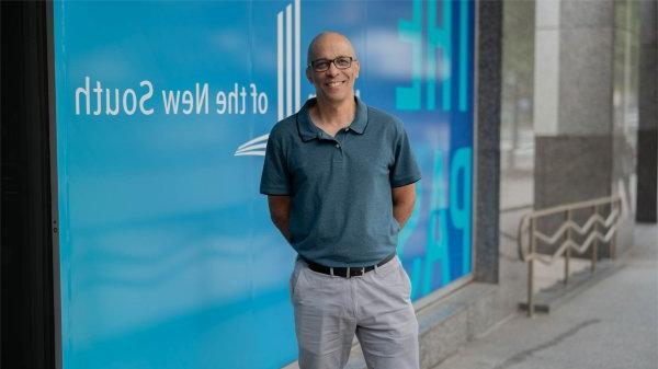 Chris Barbee posing in blue shirt